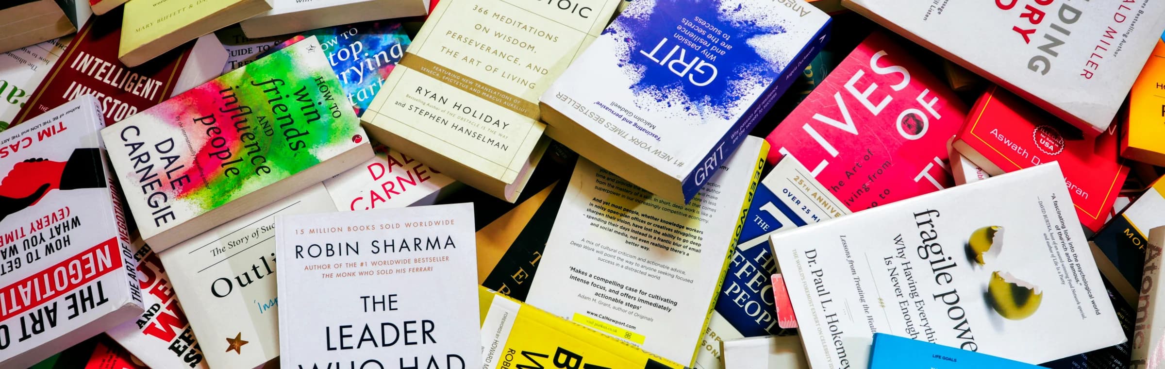 A colorful arrangement of books scattered across a table